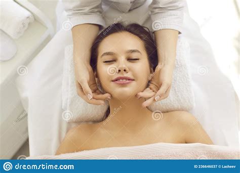 Happy Relaxed Woman Getting Facial Skin Treatment And Face Massage At Spa Center Stock Image