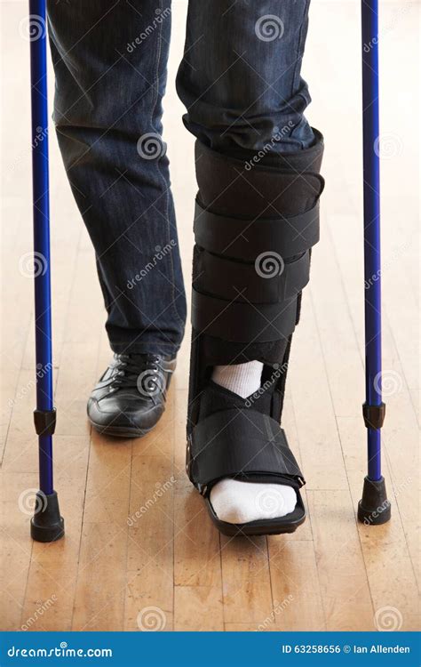 Close Up Of Man Walking With Crutches And Cast Stock Photo Image Of