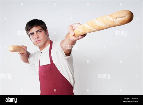 Man Holding Baguettes In Both Hands Stock Photo Alamy