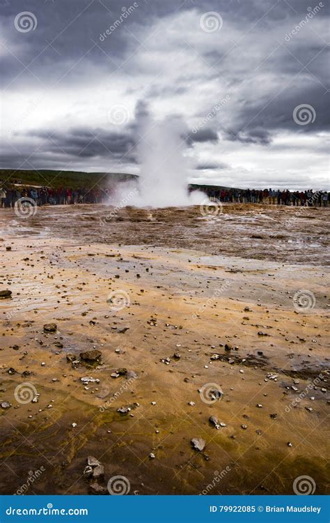The Icelandic Geyser Strokkur Erupting Into A Dramatic Cloudy Stock