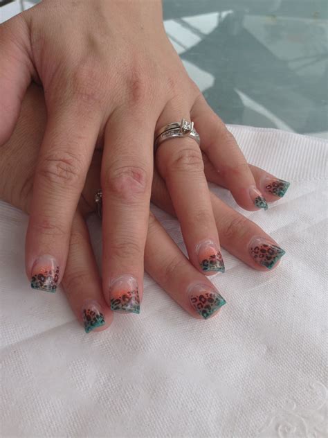 These nails looks perfect for summer or winter season. Teal and coral leopard print acrylic nails | Acrylic nails ...