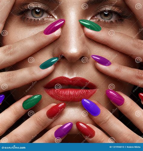 Beautiful Girl With A Classic Make Up And Multi Colored Nails Manicure