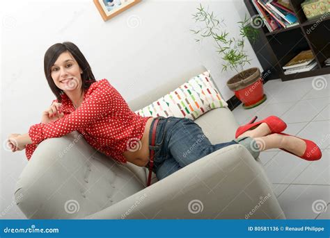 Young Woman With Jeans Lying In The Sofa Stock Photo Image Of Smile