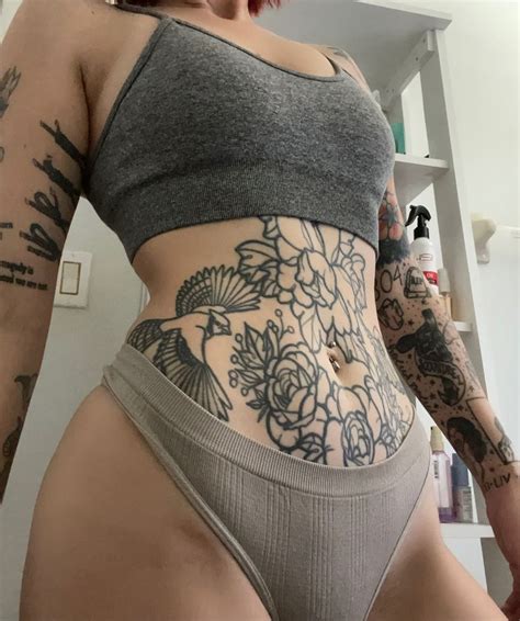 a woman with tattoos on her stomach
