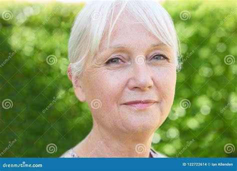 Outdoor Head And Shoulders Portrait Of Serious Senior Woman Stock Photo