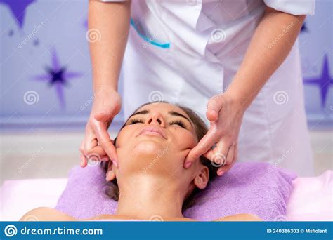 relaxing massage european woman getting facial massage in spa salon side view stock image