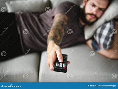 Man Lying On A Couch Watching Tv Stock Photo Image Of Entertainment Favorite