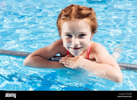 Close Up Portrait Of Happy Little Child In Bikini In Swimming Pool