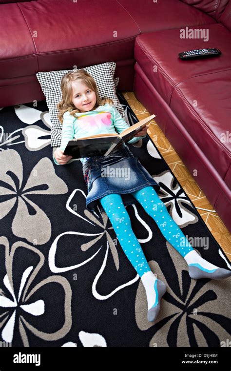 Little Girl Reading A Book At Home Stock Photo Alamy