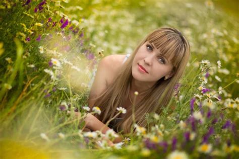 Beautiful Blond Woman Sitting In Tall Grass Stock Photo Dmbaker