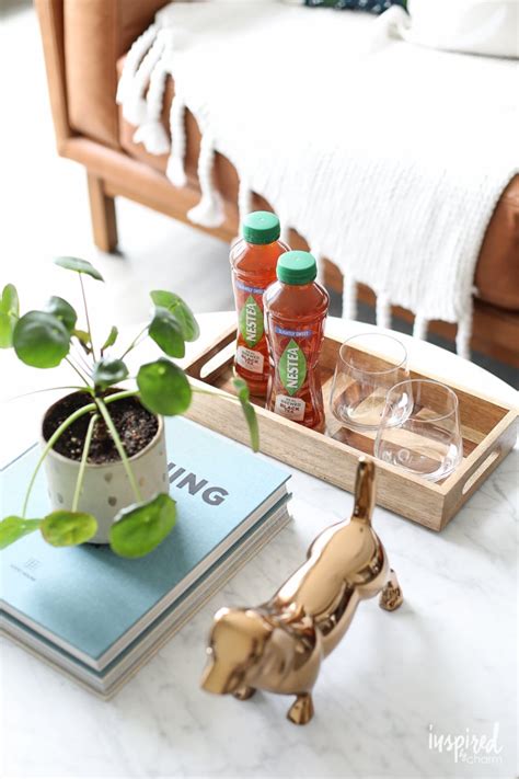 I love that they keep everything neatly corralled and if you want to clear off your coffee table to use it for playing a game or setting out a spread of food, you can take everything off with the simple lift of a tray. Simple Coffee Table Styling Ideas - Inspired by Charm