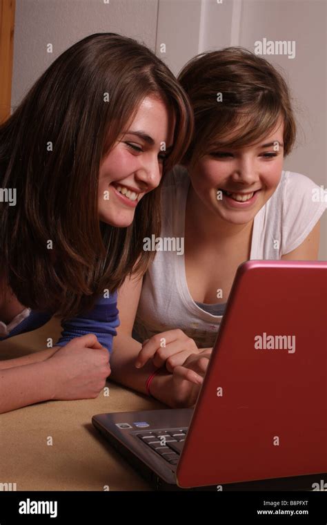 Two Teenage Girls Using A Laptop Computer Stock Photo Alamy
