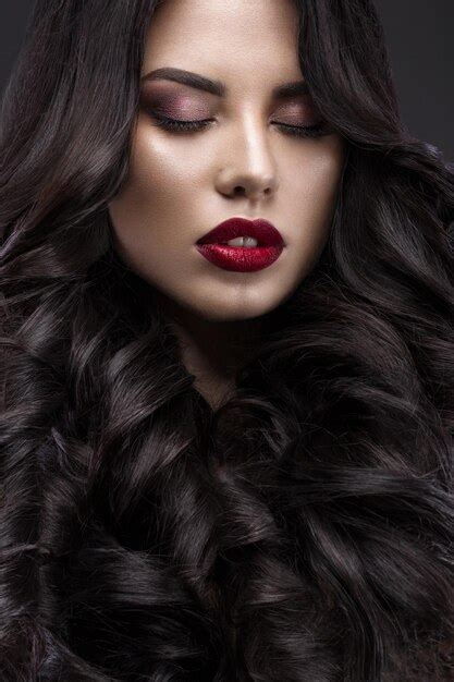 Premium Photo Beautiful Brunette Model Curls Classic Makeup And Red