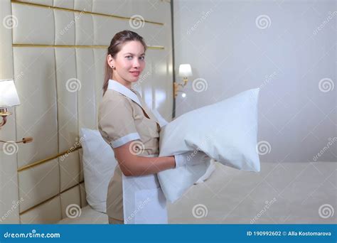 Maid Service In The Hotel Room Cleaning Of Hotel Rooms A Girl In