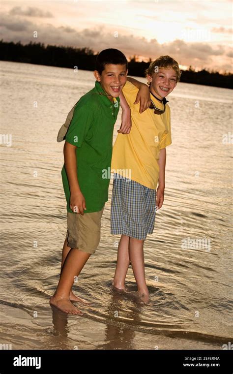 Portrait Of Two Boys Standing On The Beach Stock Photo Alamy
