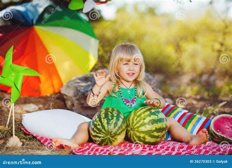Cute Little Girl Playing With Watermelons In Summer Park Outdoors Stock