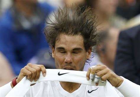 Rafael Nadal Of Spain Throws His Head Back As He Changes His Headband