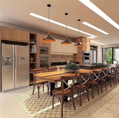 A Large Kitchen With An Island Table Surrounded By Wooden Chairs And