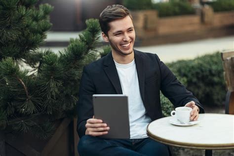 Premium Photo Portrait Of Smiling Male In Casual Wear Checking Email