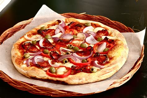 Pizza With Spianata Calabrese Green Olives Red Onions And Paprica