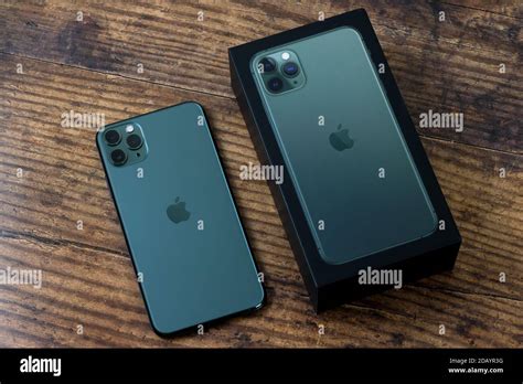 Iphone 11 Pro Max In Midnight Green Color Next To Its Box Stock Photo