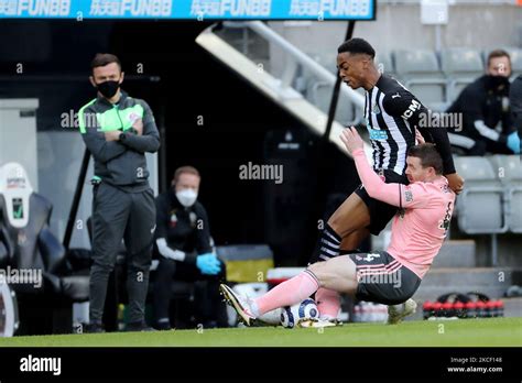 joe willock of newcastle united battles with john fleck during the premier league match between