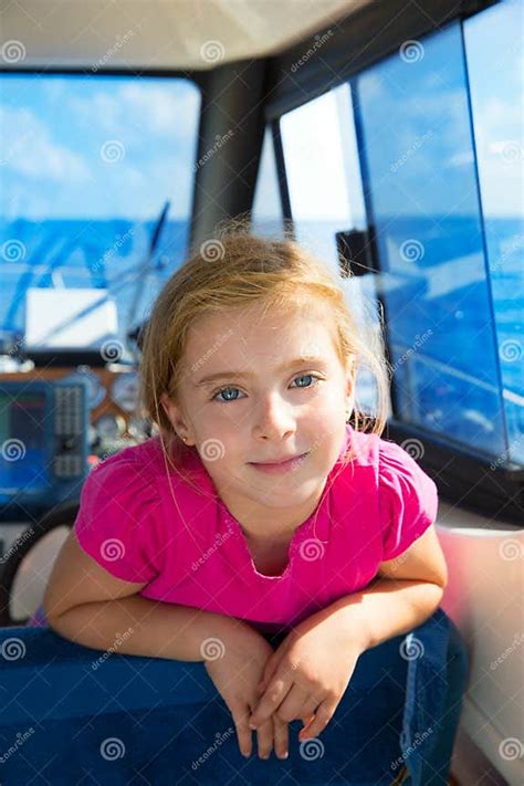 Blond Kid Girl At Boat Indoor Sailing Smiling Happy Stock Photo Image