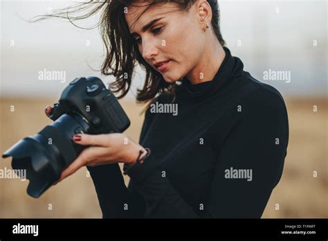 Photographer Checking Pictures On Dslr Camera Young Woman Wearing