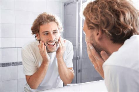 Young Man Washing Face With Soap Near Mirror Stock Image Image Of