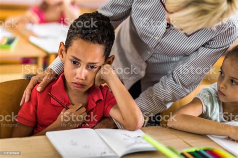 African American Elementary Student Crying On A Class While His Teacher