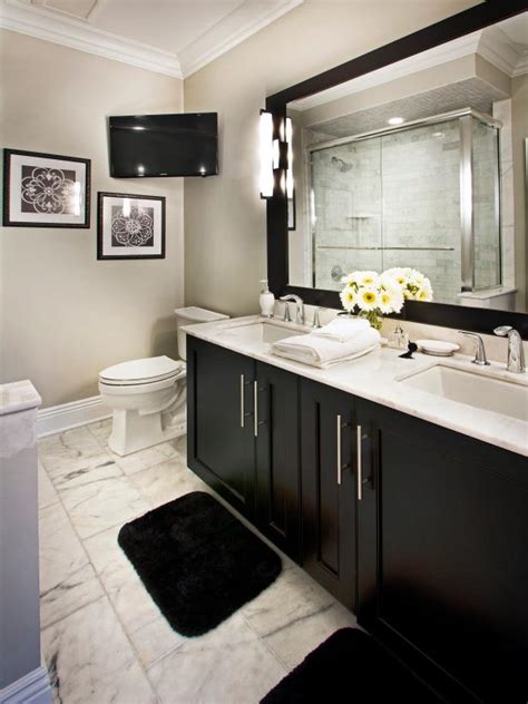 In this bathroom, the frame on the mirror is enough to make this vanity pop. Classic Black and White Bathroom With Marble Floor | HGTV