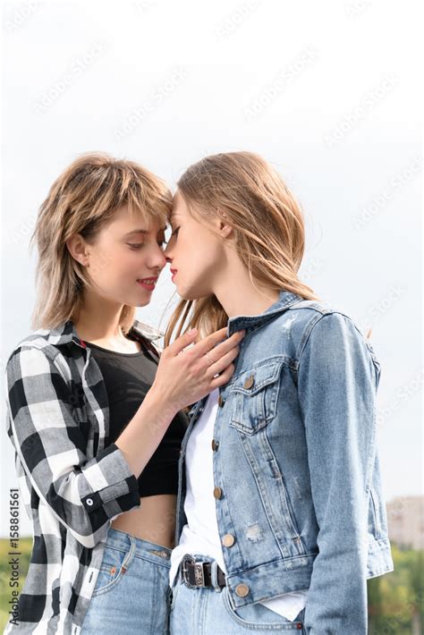 Young Lesbian Couple Kissing With Eyes Closed Outdoors Stock Photo