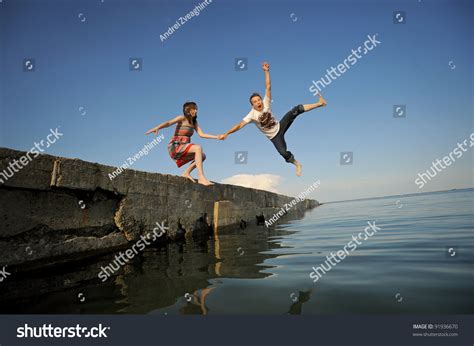 Young Couple Jumping Pier Into Water Stock Photo Edit Now 91936670