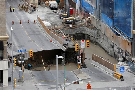 4 Lane Wide Sinkhole Swallows Car In Canada Picture Incredible Sinkholes Around The World