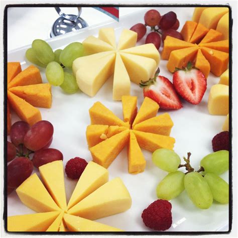 Platter Of Fruit And Pretty Cheese Flowers Out Of Gouda Wheels