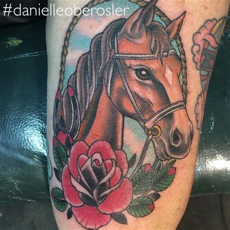 A Tattoo With A Horse And Roses On It