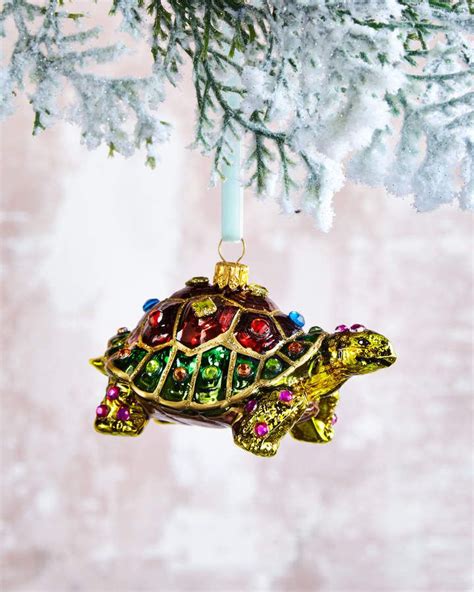 An Ornament Shaped Like A Turtle Hanging From A Christmas Tree