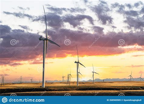 Windmills At Sunset Producing Green Energy Overlooking Agriculture
