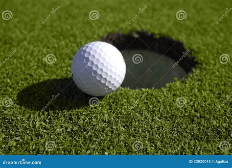 Golf Ball Sits At The Edge Of The Hole Stock Image Image Of Greenside