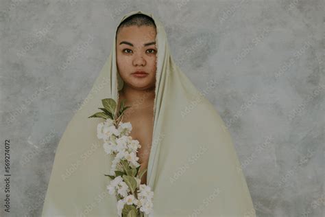 Portrait Of A Plus Size Filipino Woman With A Shaved Head Wearing A