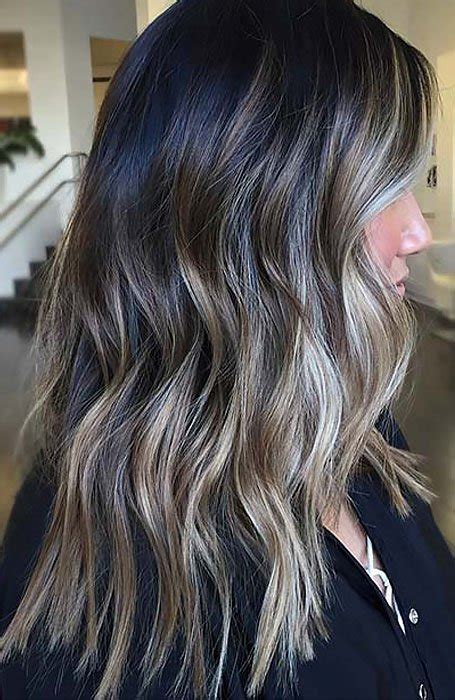 If the styling is made in the right fashion, this hairstyle will bring an amazing the curly hair is blonde and styled with a blowout fade haircut. 25 Sexy Black Hair With Highlights for 2020 - The Trend ...
