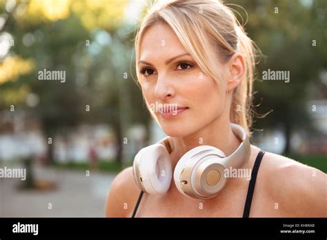 Picture Of Concentrated Strong Young Sports Woman Outdoors Listening