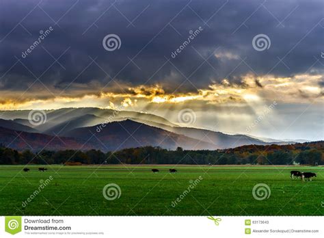 Beautiful Sun Rays Through The Clouds Over Mountains Stock