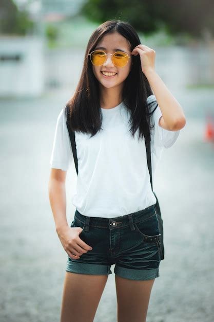 premium photo asian teenager toothy smiling face standing outdoor