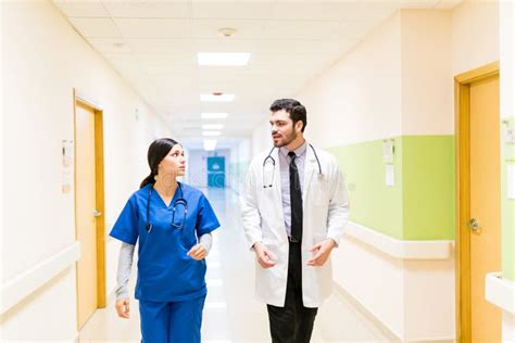 Healthcare Workers Talking In Hospital Corridor Stock Photo Image Of