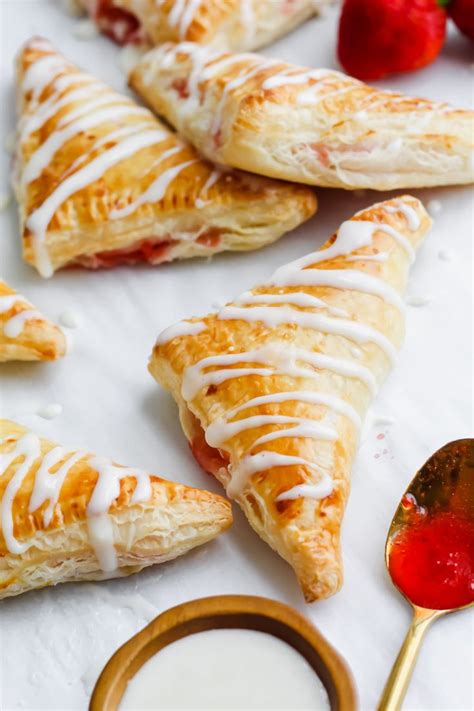 Strawberry Turnovers With White Glaze And Strawberries On The Side