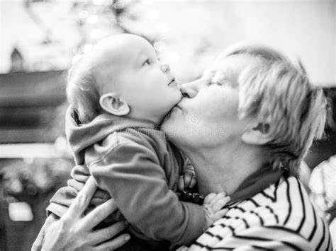 grandmother kiss her grandson love moment stock image image of woman holding 106580375