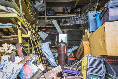 Big mess in an over stuffed suburban garage. - Brad's Junk Removal