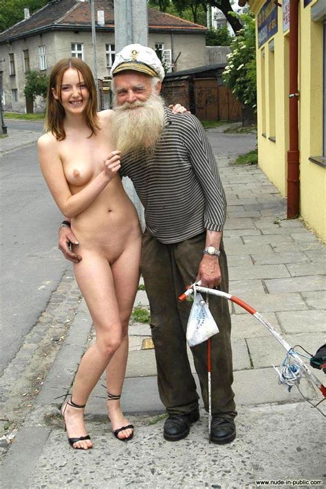 she is posing with a stranger on the street while nudeshots