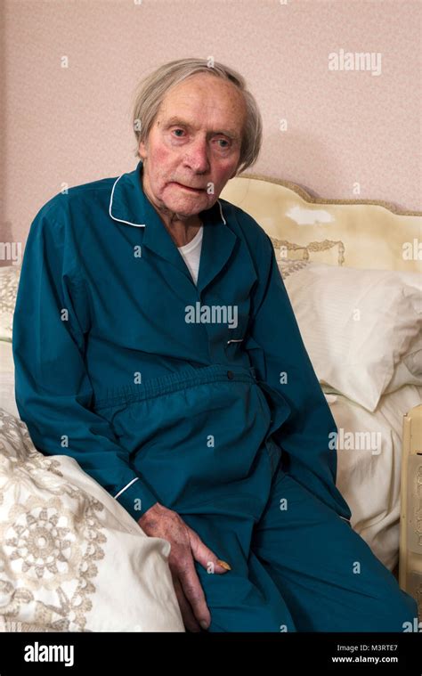 Elderly Man Getting Into Bed Stock Photo Alamy